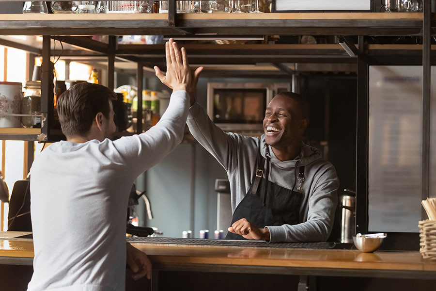 Insurance Quote - Happy Bartender Giving His Friend High Five